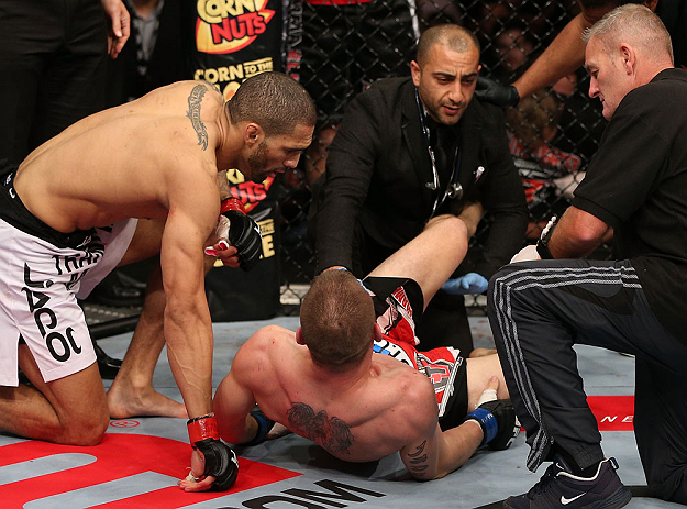 NOTTINGHAM, ENGLAND - SEPTEMBER 29: (L-R) Che Mills checks on opponent Duane Ludwig after Ludwig suffered a knee injury during their welterweight fight at the UFC on Fuel TV event at Capital FM Arena on September 29, 2012 in Nottingham, England. (Photo by Josh Hedges/Zuffa LLC/Zuffa LLC via Getty Images)
