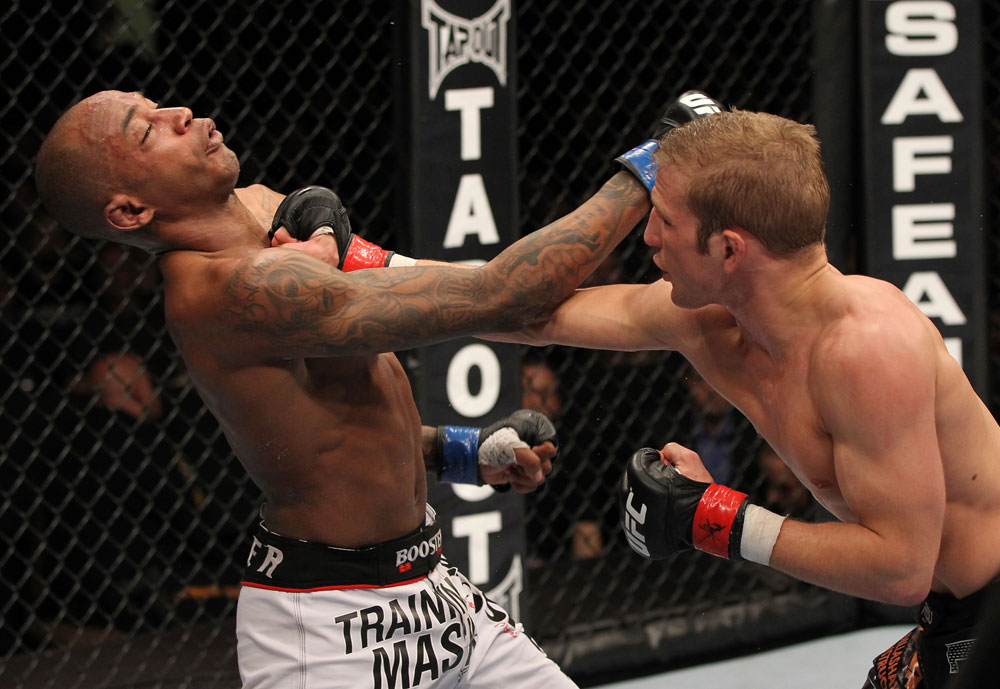 OMAHA, NE - FEBRUARY 15: (R-L) TJ Dillashaw punches Walel Watson during the UFC on FUEL TV event at Omaha Civic Auditorium on February 15, 2012 in Omaha, Nebraska. (Photo by Josh Hedges/Zuffa LLC/Zuffa LLC via Getty Images) *** Local Caption *** TJ Dillashaw; Walel Watson