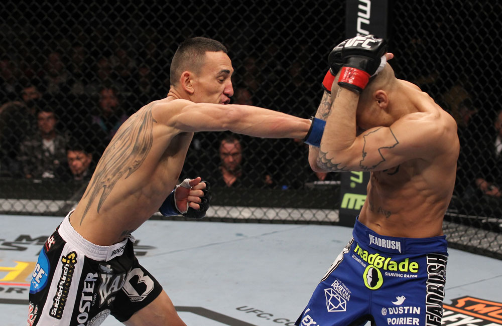 LAS VEGAS, NV - FEBRUARY 04:  Max Holloway (left) punches Dustin Poirier during the UFC 143 event at Mandalay Bay Events Center on February 4, 2012 in Las Vegas, Nevada.  (Photo by Nick Laham/Zuffa LLC/Zuffa LLC via Getty Images) *** Local Caption *** Max Holloway; Dustin Poirier