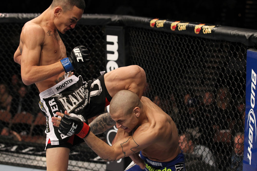 LAS VEGAS, NV - FEBRUARY 04:  Max Holloway (black shorts) delivers a knee to Dustin Poirier during the UFC 143 event at Mandalay Bay Events Center on February 4, 2012 in Las Vegas, Nevada.  (Photo by Nick Laham/Zuffa LLC/Zuffa LLC via Getty Images) *** Local Caption *** Max Holloway; Dustin Poirier