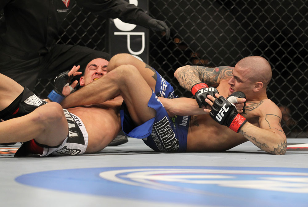 LAS VEGAS, NV - FEBRUARY 04:  Dustin Poirier (blue shorts) attempts to submit Max Holloway during the UFC 143 event at Mandalay Bay Events Center on February 4, 2012 in Las Vegas, Nevada.  (Photo by Josh Hedges/Zuffa LLC/Zuffa LLC via Getty Images) *** Local Caption *** Dustin Poirier; Max Holloway