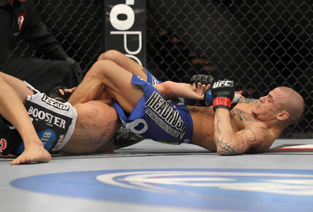 LAS VEGAS, NV - FEBRUARY 04:  Dustin Poirier (blue shorts) attempts to submit Max Holloway during the UFC 143 event at Mandalay Bay Events Center on February 4, 2012 in Las Vegas, Nevada.  (Photo by Josh Hedges/Zuffa LLC/Zuffa LLC via Getty Images) *** Local Caption *** Dustin Poirier