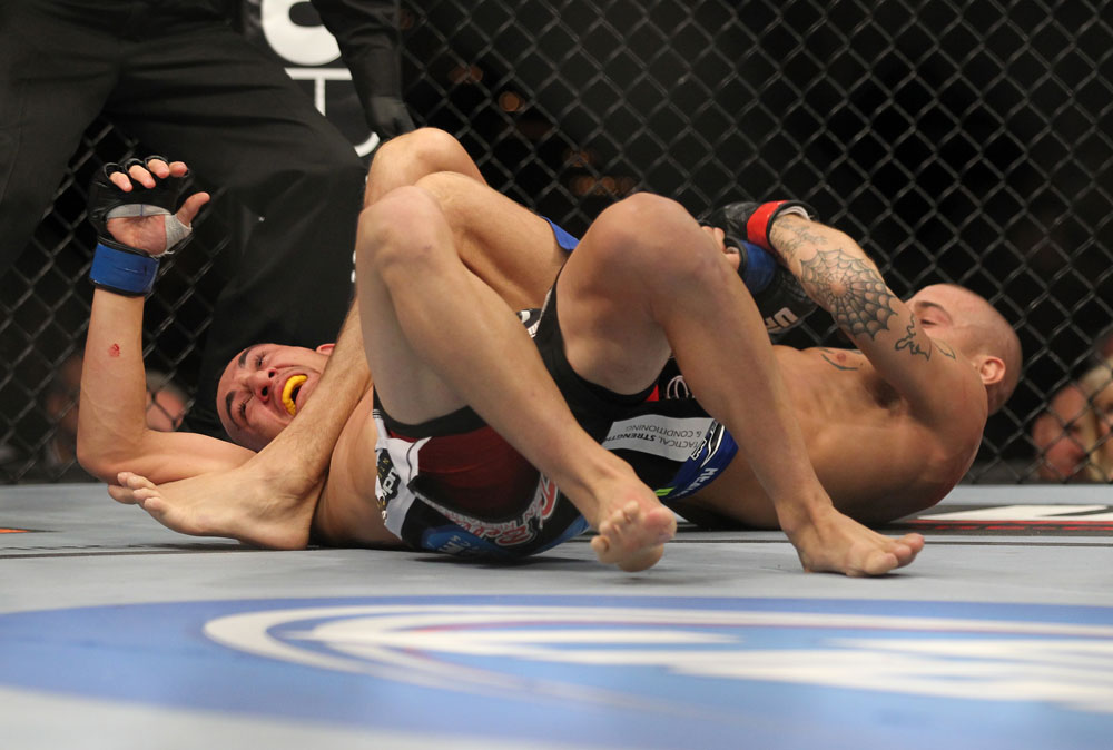 LAS VEGAS, NV - FEBRUARY 04:  Dustin Poirier (right) attempts to submit Max Holloway during the UFC 143 event at Mandalay Bay Events Center on February 4, 2012 in Las Vegas, Nevada.  (Photo by Josh Hedges/Zuffa LLC/Zuffa LLC via Getty Images) *** Local Caption *** Dustin Poirier; Max Holloway