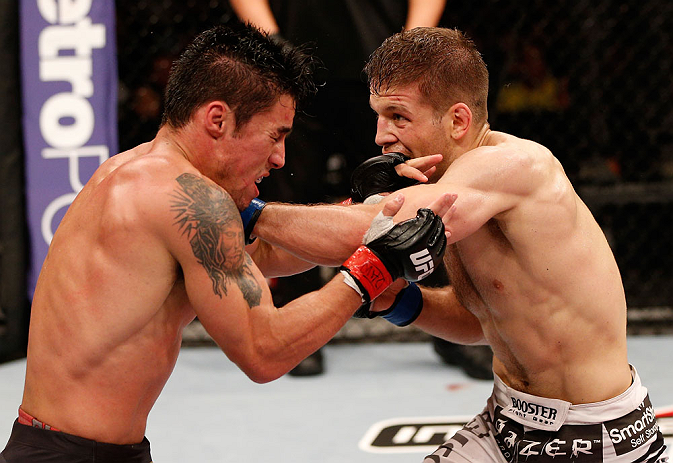 SAO PAULO, BRAZIL - JANUARY 19: Nik Lentz (white shorts) punches Diego Nunes in their featherweight fight at the UFC on FX event on January 19, 2013 at Ibirapuera Gymnasium in Sao Paulo, Brazil. (Photo by Josh Hedges/Zuffa LLC/Zuffa LLC via Getty Images)