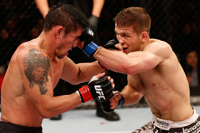SAO PAULO, BRAZIL - JANUARY 19: Nik Lentz (white shorts) punches Diego Nunes in their featherweight fight at the UFC on FX event on January 19, 2013 at Ibirapuera Gymnasium in Sao Paulo, Brazil. (Photo by Josh Hedges/Zuffa LLC/Zuffa LLC via Getty Images)