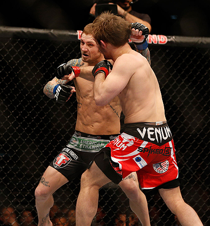 LAS VEGAS, NV - DECEMBER 29:  Brad Pickett (red shorts) punches Eddie Wineland during their bantamweight fight at UFC 155 on December 29, 2012 at MGM Grand Garden Arena in Las Vegas, Nevada. (Photo by Josh Hedges/Zuffa LLC/Zuffa LLC via Getty Images) *** Local Caption *** Brad Pickett; Eddie Wineland