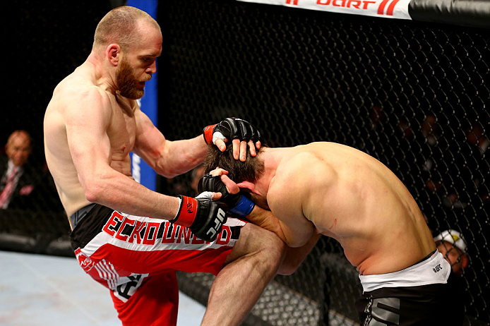 CHICAGO, IL - JANUARY 26:  TJ Grant (L) knees Matt Wiman (R) during their Lightweight Bout part of UFC on FOX at United Center on January 26, 2013 in Chicago, Illinois.  (Photo by Al Bello/Zuffa LLC/Zuffa LLC Via Getty Images)