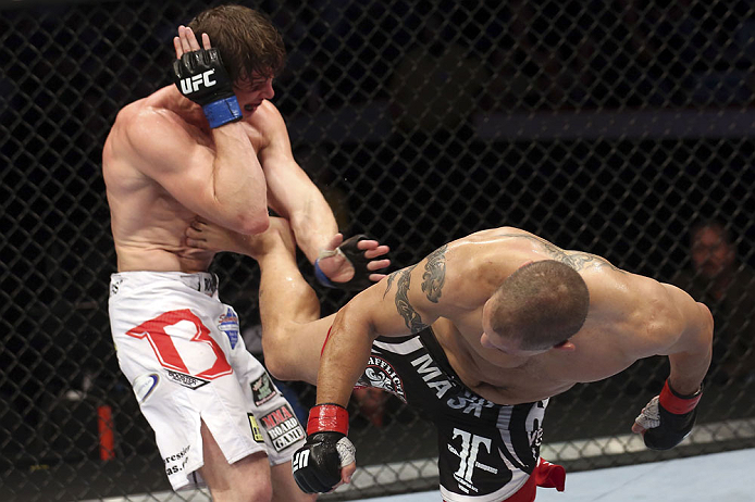 CALGARY, CANADA - JULY 21: (R-L) Chris Clements lands a kick to the ribs of Matthew Riddle during their welterweight bout at UFC 149 inside the Scotiabank Saddledome on July 21, 2012 in Calgary, Alberta, Canada.  (Photo by Nick Laham/Zuffa LLC/Zuffa LLC via Getty Images)