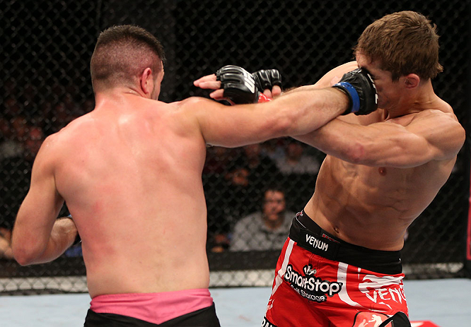 NOTTINGHAM, ENGLAND - SEPTEMBER 29: (L-R) John Maguire punches John Hathaway during their welterweight fight at the UFC on Fuel TV event at Capital FM Arena on September 29, 2012 in Nottingham, England. (Photo by Josh Hedges/Zuffa LLC/Zuffa LLC via Getty Images)