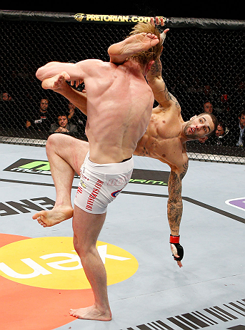 LONDON, ENGLAND - FEBRUARY 16: (R-L) Che Mills kicks Matthew Riddle after a takedown in their welterweight fight during the UFC on Fuel TV event on February 16, 2013 at Wembley Arena in London, England. (Photo by Josh Hedges/Zuffa LLC/Zuffa LLC via Getty Images)