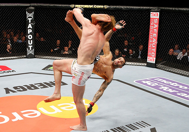 LONDON, ENGLAND - FEBRUARY 16: (R-L) Che Mills kicks Matthew Riddle after a takedown in their welterweight fight during the UFC on Fuel TV event on February 16, 2013 at Wembley Arena in London, England. (Photo by Josh Hedges/Zuffa LLC/Zuffa LLC via Getty Images)