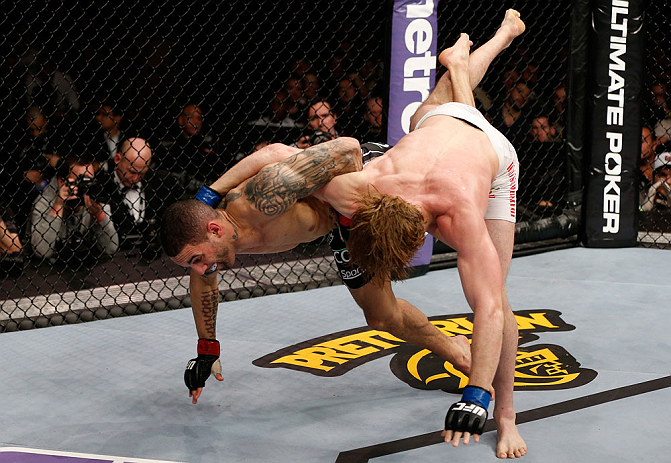 LONDON, ENGLAND - FEBRUARY 16: (L-R) Che Mills attempts to throw Matthew Riddle to the mat in their welterweight fight during the UFC on Fuel TV event on February 16, 2013 at Wembley Arena in London, England. (Photo by Josh Hedges/Zuffa LLC/Zuffa LLC via Getty Images)