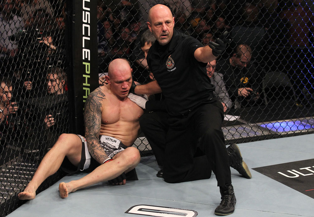 TORONTO, ON - DECEMBER 10:  (R-L) Referee Yves Lavigne calls for a doctor after Krzysztof Soszynski was knocked out by Igor Pokrajac during the UFC 140 event at Air Canada Centre on December 10, 2011 in Toronto, Ontario, Canada.  (Photo by Nick Laham/Zuffa LLC/Zuffa LLC via Getty Images)