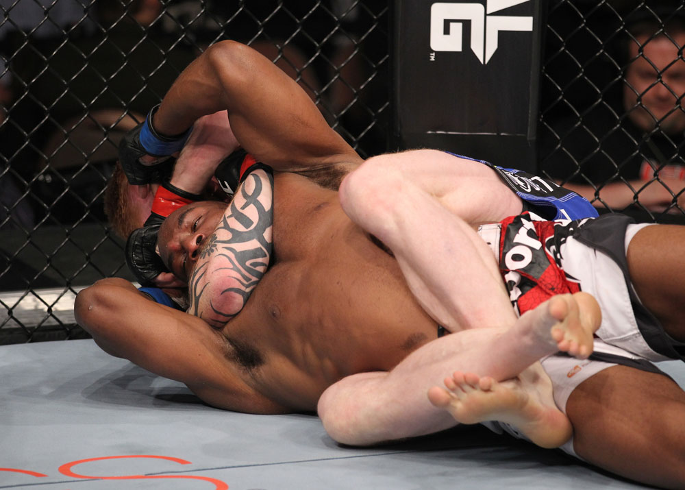 LAS VEGAS, NV - FEBRUARY 04:  Ed Herman attempts to submit Clifford Starks (red/white/black shorts) during the UFC 143 event at Mandalay Bay Events Center on February 4, 2012 in Las Vegas, Nevada.  (Photo by Nick Laham/Zuffa LLC/Zuffa LLC via Getty Images) *** Local Caption *** Ed Herman; Clifford Starks