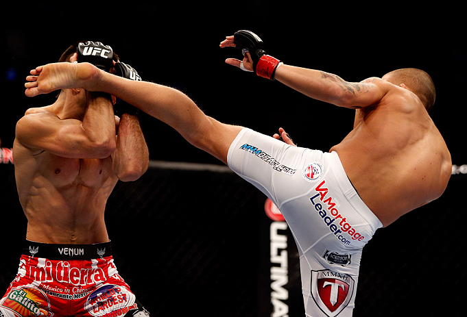 CHICAGO, IL - JANUARY 26:  Erik Koch (R) kicks Ricardo Lamas (L) during their Featherweight Bout part of UFC on FOX at United Center on January 26, 2013 in Chicago, Illinois.  (Photo by Josh Hedges/Zuffa LLC/Zuffa LLC Via Getty Images)