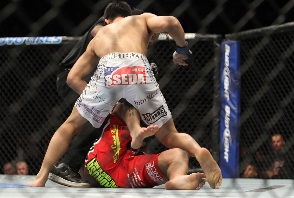 TORONTO, ON - DECEMBER 10:  "The Korean Zombie" Chan Sung Jung (white shorts) defeats Mark Hominick by knockout during the UFC 140 event at Air Canada Centre on December 10, 2011 in Toronto, Ontario, Canada.  (Photo by Josh Hedges/Zuffa LLC/Zuffa LLC via Getty Images)