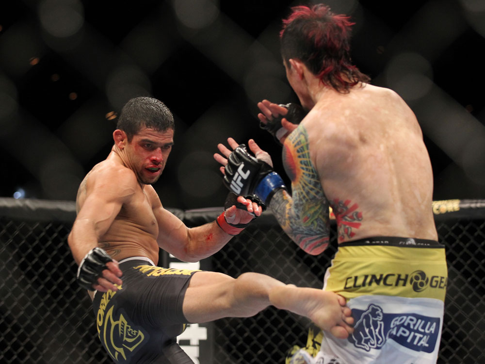 LAS VEGAS, NV - FEBRUARY 04:  Renan Barao (left) kicks Scott Jorgensen during the UFC 143 event at Mandalay Bay Events Center on February 4, 2012 in Las Vegas, Nevada.  (Photo by Josh Hedges/Zuffa LLC/Zuffa LLC via Getty Images) *** Local Caption *** Renan Barao; Scott Jorgensen