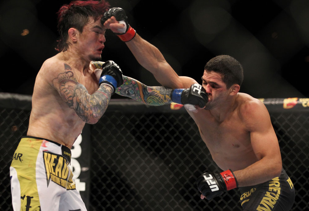 LAS VEGAS, NV - FEBRUARY 04:  (L-R) Scott Jorgensen and Renan Barao exchange punches during the UFC 143 event at Mandalay Bay Events Center on February 4, 2012 in Las Vegas, Nevada.  (Photo by Josh Hedges/Zuffa LLC/Zuffa LLC via Getty Images) *** Local Caption *** Scott Jorgensen; Renan Barao
