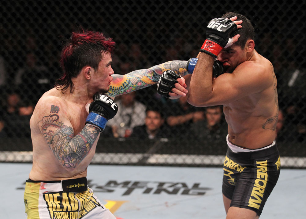LAS VEGAS, NV - FEBRUARY 04:  Scott Jorgensen (left) punches Renan Barao during the UFC 143 event at Mandalay Bay Events Center on February 4, 2012 in Las Vegas, Nevada.  (Photo by Nick Laham/Zuffa LLC/Zuffa LLC via Getty Images) *** Local Caption *** Scott Jorgensen; Renan Barao