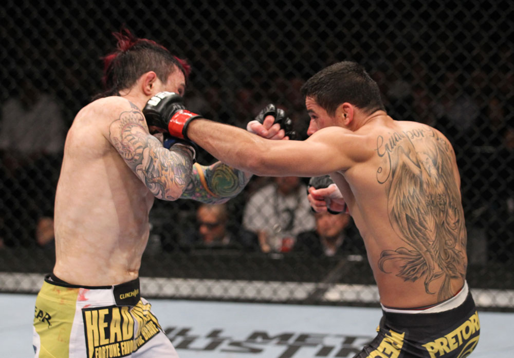LAS VEGAS, NV - FEBRUARY 04:  Renan Barao (right) punches Scott Jorgensen during the UFC 143 event at Mandalay Bay Events Center on February 4, 2012 in Las Vegas, Nevada.  (Photo by Nick Laham/Zuffa LLC/Zuffa LLC via Getty Images) *** Local Caption *** Renan Barao; Scott Jorgensen