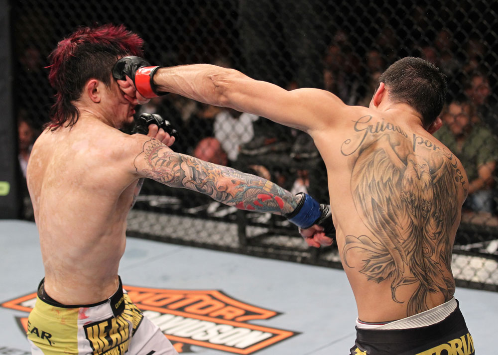 LAS VEGAS, NV - FEBRUARY 04:  Renan Barao (right) punches Scott Jorgensen during the UFC 143 event at Mandalay Bay Events Center on February 4, 2012 in Las Vegas, Nevada.  (Photo by Nick Laham/Zuffa LLC/Zuffa LLC via Getty Images) *** Local Caption *** Renan Barao; Scott Jorgensen