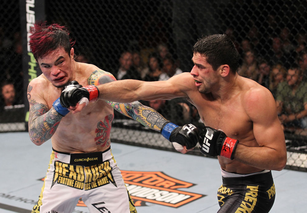 LAS VEGAS, NV - FEBRUARY 04:  Scott Jorgensen (left) and Renan Barao (right) exchange punches during the UFC 143 event at Mandalay Bay Events Center on February 4, 2012 in Las Vegas, Nevada.  (Photo by Nick Laham/Zuffa LLC/Zuffa LLC via Getty Images) *** Local Caption *** Scott Jorgensen; Renan Barao
