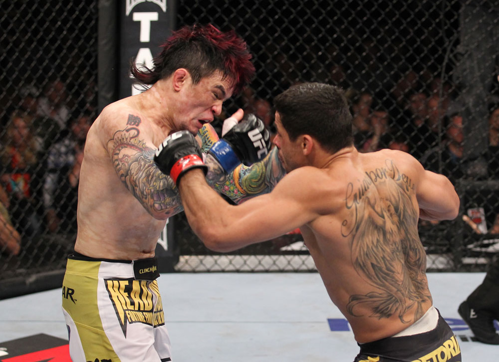 LAS VEGAS, NV - FEBRUARY 04:  Renan Barao (right) punches Scott Jorgensen during the UFC 143 event at Mandalay Bay Events Center on February 4, 2012 in Las Vegas, Nevada.  (Photo by Nick Laham/Zuffa LLC/Zuffa LLC via Getty Images) *** Local Caption *** Renan Barao; Scott Jorgensen