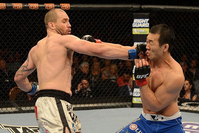 LAS VEGAS, NV - DECEMBER 29:  (L-R) Alan Belcher punches Yushin Okami during their middleweight fight at UFC 155 on December 29, 2012 at MGM Grand Garden Arena in Las Vegas, Nevada. (Photo by Donald Miralle/Zuffa LLC/Zuffa LLC via Getty Images) *** Local Caption *** Yushin Okami; Alan Belcher