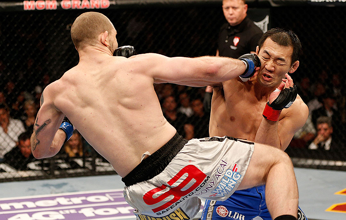 LAS VEGAS, NV - DECEMBER 29:  (L-R) Alan Belcher punches Yushin Okami during their middleweight fight at UFC 155 on December 29, 2012 at MGM Grand Garden Arena in Las Vegas, Nevada. (Photo by Josh Hedges/Zuffa LLC/Zuffa LLC via Getty Images) *** Local Caption *** Yushin Okami; Alan Belcher