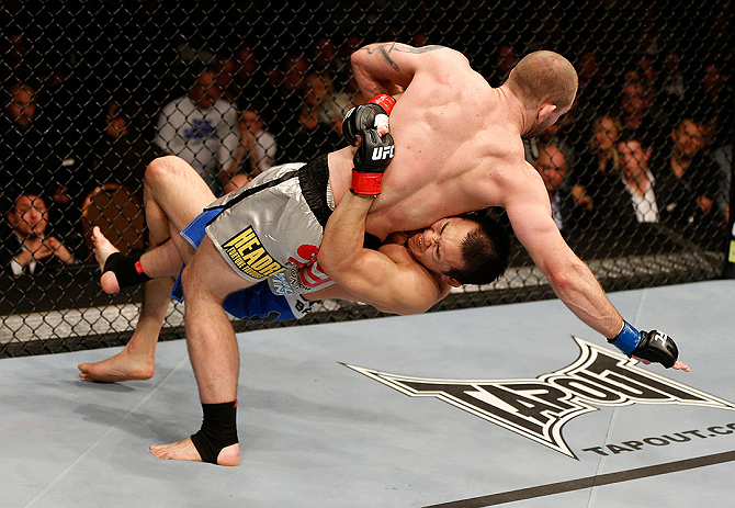 LAS VEGAS, NV - DECEMBER 29:  Yushin Okami (bottom) lifts Alan Belcher during their middleweight fight at UFC 155 on December 29, 2012 at MGM Grand Garden Arena in Las Vegas, Nevada. (Photo by Josh Hedges/Zuffa LLC/Zuffa LLC via Getty Images) *** Local Caption *** Yushin Okami; Alan Belcher