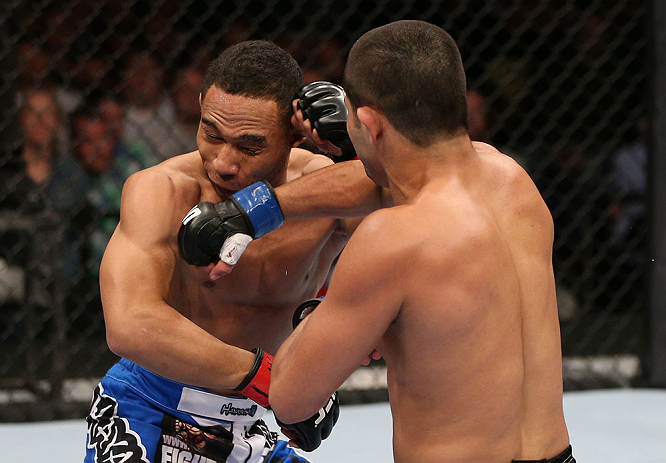 MINNEAPOLIS, MN - OCTOBER 05: (R-L) Jussier Formiga punches John Dodson during their flyweight fight at the UFC on FX event at Target Center on October 5, 2012 in Minneapolis, Minnesota. (Photo by Josh Hedges/Zuffa LLC/Zuffa LLC via Getty Images)