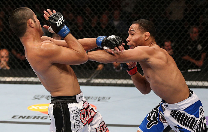 MINNEAPOLIS, MN - OCTOBER 05: (R-L) John Dodson punches Jussier Formiga during their flyweight fight at the UFC on FX event at Target Center on October 5, 2012 in Minneapolis, Minnesota. (Photo by Josh Hedges/Zuffa LLC/Zuffa LLC via Getty Images)