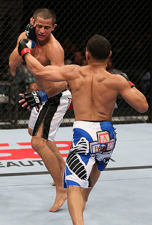 MINNEAPOLIS, MN - OCTOBER 05: (R-L) John Dodson punches Jussier Formiga during their flyweight fight at the UFC on FX event at Target Center on October 5, 2012 in Minneapolis, Minnesota. (Photo by Josh Hedges/Zuffa LLC/Zuffa LLC via Getty Images)
