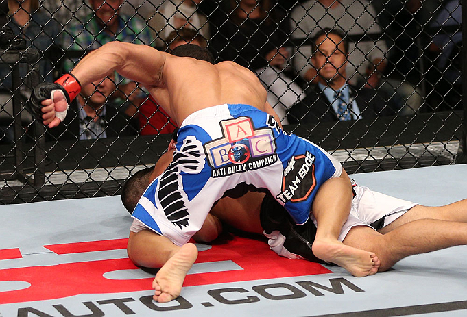 MINNEAPOLIS, MN - OCTOBER 05: (L-R) John Dodson punches Jussier Formiga during their flyweight fight at the UFC on FX event at Target Center on October 5, 2012 in Minneapolis, Minnesota. (Photo by Josh Hedges/Zuffa LLC/Zuffa LLC via Getty Images)