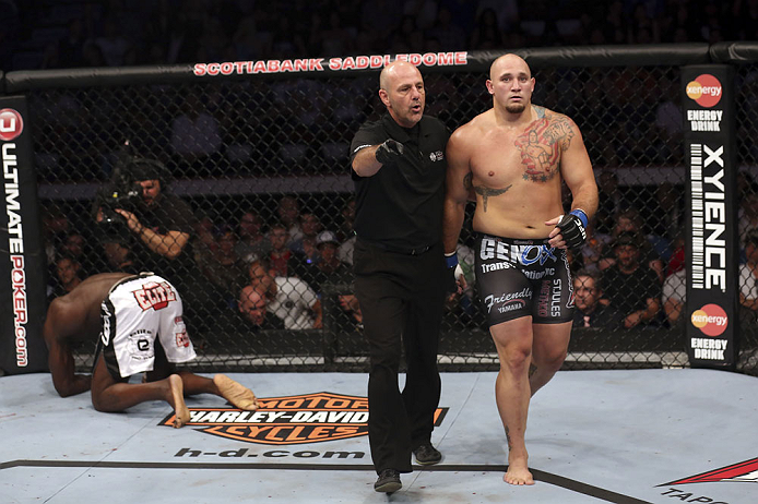 CALGARY, CANADA - JULY 21: (L-R) Cheick Kongo kneels after Shawn Jordan hit him with an accidental elbow below the belt during their heavyweight bout at UFC 149 inside the Scotiabank Saddledome on July 21, 2012 in Calgary, Alberta, Canada.  (Photo by Nick Laham/Zuffa LLC/Zuffa LLC via Getty Images)