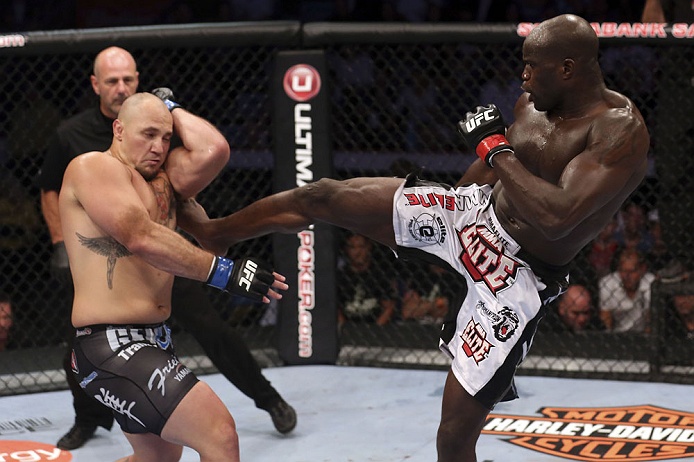 CALGARY, CANADA - JULY 21: (R-L) Cheick Kongo lands a kick to the body of Shawn Jordan during their heavyweight bout at UFC 149 inside the Scotiabank Saddledome on July 21, 2012 in Calgary, Alberta, Canada.  (Photo by Nick Laham/Zuffa LLC/Zuffa LLC via Getty Images)