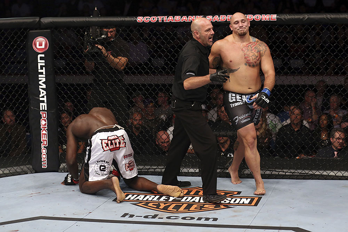 CALGARY, CANADA - JULY 21: (L-R) Cheick Kongo kneels after Shawn Jordan hit him with an accidental elbow below the belt during their heavyweight bout at UFC 149 inside the Scotiabank Saddledome on July 21, 2012 in Calgary, Alberta, Canada.  (Photo by Nick Laham/Zuffa LLC/Zuffa LLC via Getty Images)