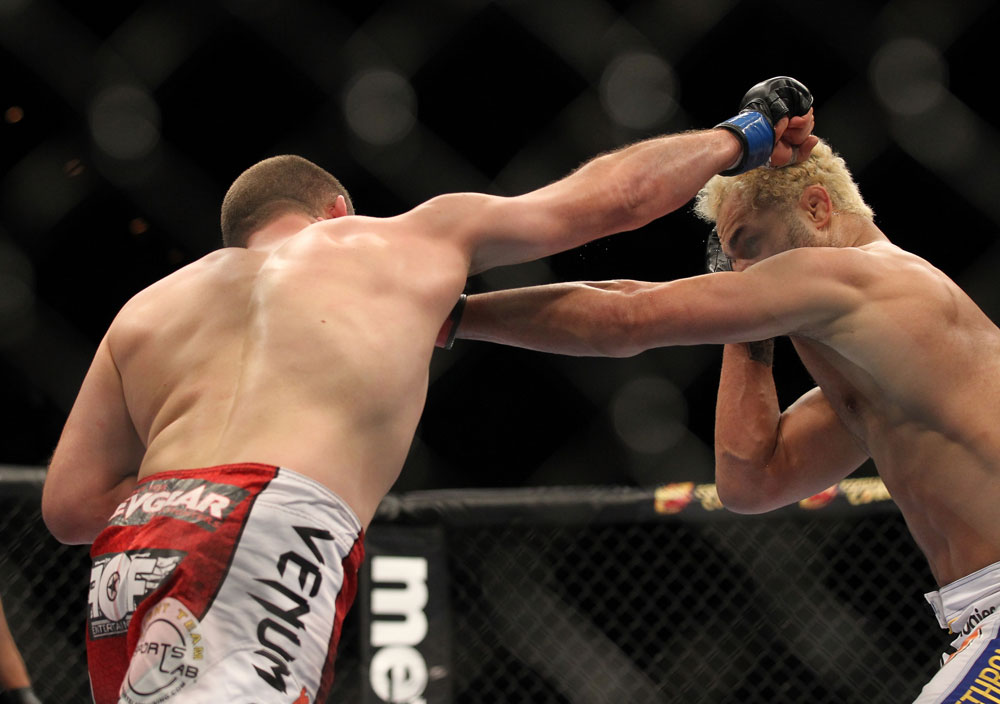 LAS VEGAS, NV - FEBRUARY 04:  (L-R) Mike Pierce and Josh Koscheck exchange punches during the UFC 143 event at Mandalay Bay Events Center on February 4, 2012 in Las Vegas, Nevada.  (Photo by Josh Hedges/Zuffa LLC/Zuffa LLC via Getty Images) *** Local Caption *** Mike Pierce; Josh Koscheck