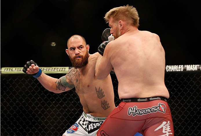 LAS VEGAS, NV - DECEMBER 28:  (L-R) Travis Browne punches Josh Barnett in their heavyweight bout during the UFC 168 event at the MGM Grand Garden Arena on December 28, 2013 in Las Vegas, Nevada. (Photo by Josh Hedges/Zuffa LLC/Zuffa LLC via Getty Images) *** Local Caption *** Josh Barnett; Travis Browne