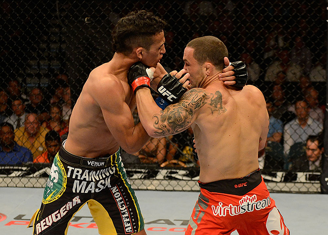 LAS VEGAS, NV - JULY 06:  (R-L) Frankie Edgar punches Charles Oliveira in their featherweight fight during the UFC 162 event inside the MGM Grand Garden Arena on July 6, 2013 in Las Vegas, Nevada.  (Photo by Donald Miralle/Zuffa LLC/Zuffa LLC via Getty Images) *** Local Caption *** Frankie Edgar; Charles Oliveira