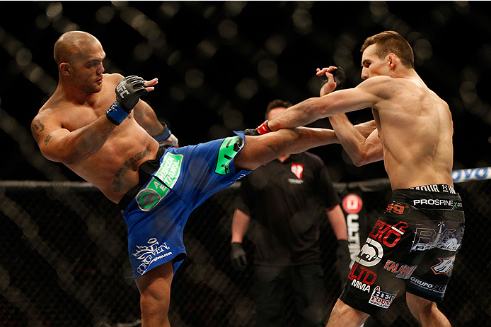 (L-R) Robbie Lawler kicks Rory MacDonald in their welterweight bout during the UFC 167 event inside the MGM Grand Garden Arena on November 16, 2013 in Las Vegas, NV. (Photo by Josh Hedges/Zuffa LLC)