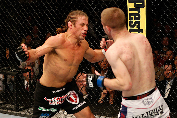 SACRAMENTO, CA - DECEMBER 14: (L-R) Urijah Faber punches Michael McDonald in their bantamweight bout during the UFC on FOX event at Sleep Train Arena on December 14, 2013 in Sacramento, California. (Photo by Josh Hedges/Zuffa LLC/Zuffa LLC via Getty Images)