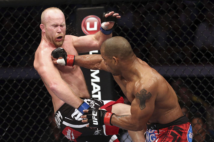 CALGARY, CANADA - JULY 21: (R-L) Hector Lombard lands a punch to the face of Tim Boetsch during their middleweight bout at UFC 149 inside the Scotiabank Saddledome on July 21, 2012 in Calgary, Alberta, Canada.  (Photo by Nick Laham/Zuffa LLC/Zuffa LLC via Getty Images)
