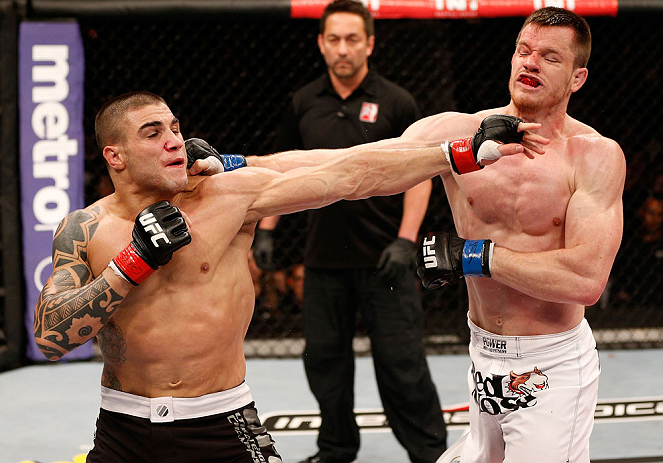SAO PAULO, BRAZIL - JANUARY 19:  (L-R) Daniel Sarafian and C.B. Dolloway trade punches in their middleweight fight at the UFC on FX event on January 19, 2013 at Ibirapuera Gymnasium in Sao Paulo, Brazil. (Photo by Josh Hedges/Zuffa LLC/Zuffa LLC via Getty Images)