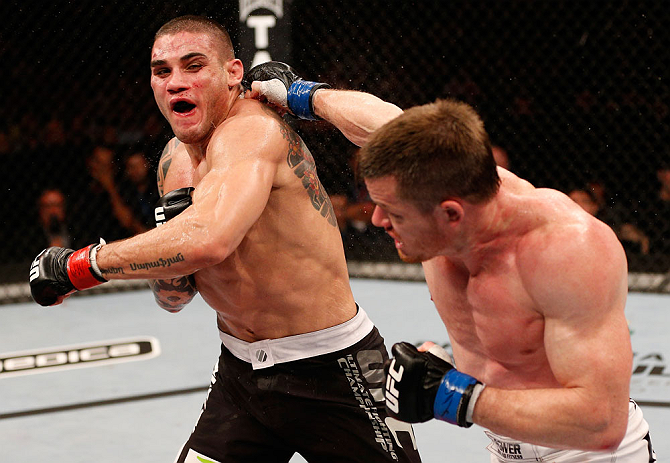 SAO PAULO, BRAZIL - JANUARY 19: (R-L) C.B. Dolloway punches Daniel Sarafian in their middleweight fight at the UFC on FX event on January 19, 2013 at Ibirapuera Gymnasium in Sao Paulo, Brazil. (Photo by Josh Hedges/Zuffa LLC/Zuffa LLC via Getty Images)