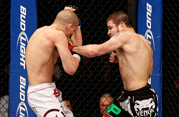 LAS VEGAS, NV - DECEMBER 29:  (R-L) Jim Miller punches Joe Lauzon during their lightweight fight at UFC 155 on December 29, 2012 at MGM Grand Garden Arena in Las Vegas, Nevada. (Photo by Josh Hedges/Zuffa LLC/Zuffa LLC via Getty Images) *** Local Caption *** Joe Lauzon; Jim Miller