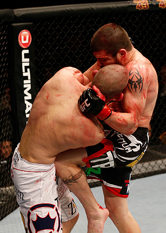 LAS VEGAS, NV - DECEMBER 29:  (R-L) Jim Miller knees Joe Lauzon during their lightweight fight at UFC 155 on December 29, 2012 at MGM Grand Garden Arena in Las Vegas, Nevada. (Photo by Josh Hedges/Zuffa LLC/Zuffa LLC via Getty Images) *** Local Caption *** Joe Lauzon; Jim Miller