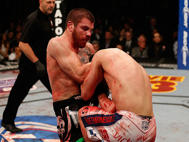LAS VEGAS, NV - DECEMBER 29:  (L-R) Jim Miller knees Joe Lauzon during their lightweight fight at UFC 155 on December 29, 2012 at MGM Grand Garden Arena in Las Vegas, Nevada. (Photo by Josh Hedges/Zuffa LLC/Zuffa LLC via Getty Images) *** Local Caption *** Joe Lauzon; Jim Miller