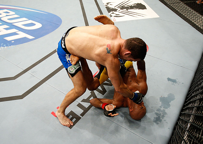 LAS VEGAS, NV - JULY 06:  Chris Weidman (top) punches Anderson Silva in their UFC middleweight championship fight during the UFC 162 event inside the MGM Grand Garden Arena on July 6, 2013 in Las Vegas, Nevada.  (Photo by Josh Hedges/Zuffa LLC/Zuffa LLC via Getty Images) *** Local Caption *** Anderson Silva; Chris Weidman