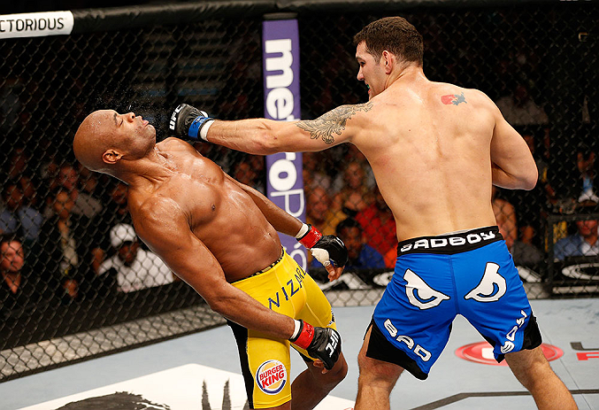LAS VEGAS, NV - JULY 06:  (R-L) Chris Weidman punches Anderson Silva in their UFC middleweight championship fight during the UFC 162 event inside the MGM Grand Garden Arena on July 6, 2013 in Las Vegas, Nevada.  (Photo by Josh Hedges/Zuffa LLC/Zuffa LLC via Getty Images) *** Local Caption *** Anderson Silva; Chris Weidman